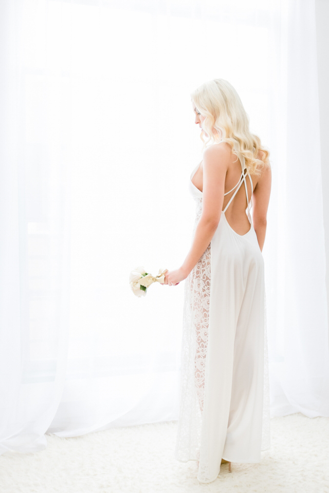 A photo of a woman in a wedding dress holding a bouquet of flowers