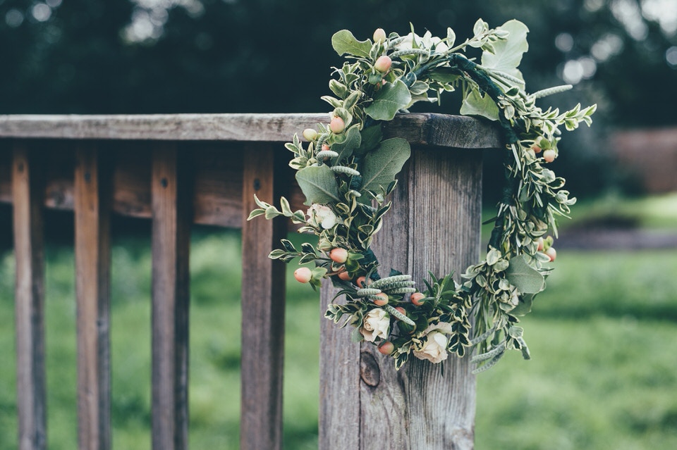 A photo of a flower crown resting on a wooden gate