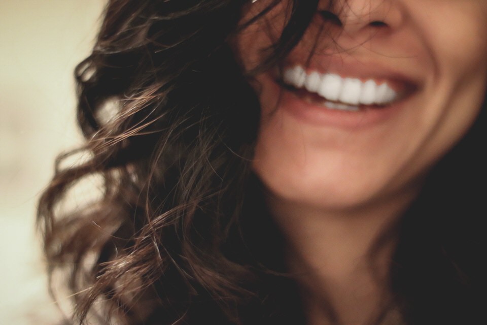 A close up photo of a woman smiling