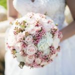 A photo of a bride holding a bouquet of flowers
