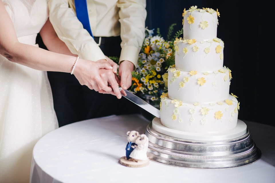 A photo of a couple cutting a wedding cake