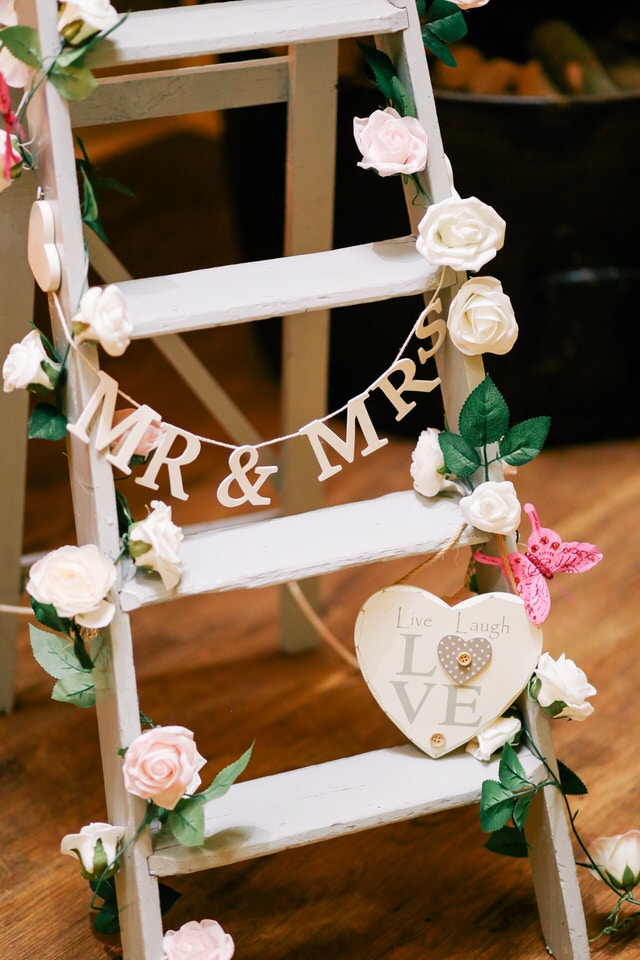 A photo of a ladder with wedding decor on it