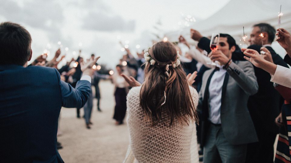 A photo of a group of people celebrating with sparklers